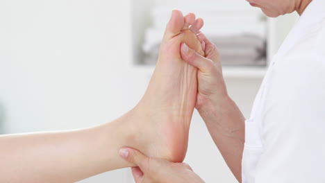 Physiotherapist-doing-foot-massage-to-her-patient