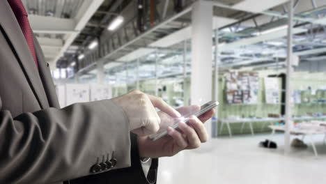 Businessman-using-smartphone-in-office