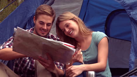 Couple-looking-at-map-in-their-tent