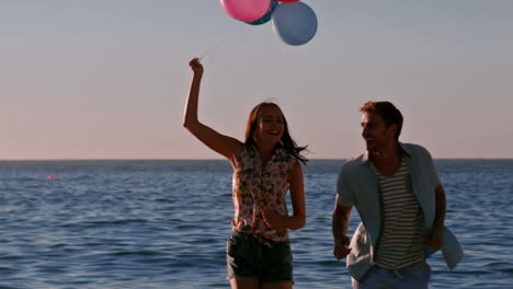 Happy-friends-running-with-balloons