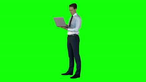 Businessman-using-laptop-on-green-screen-