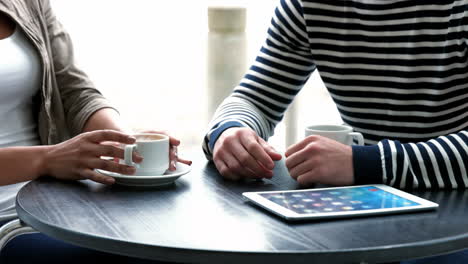 College-students-using-tablet-at-campus-cafe