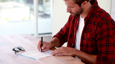 Casual-business-man-writing-on-paper-