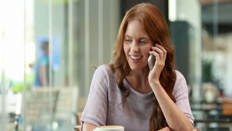 Smiling-woman-using-smartphone-and-having-phone-call