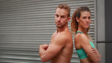 Fit-couple-posing-at-crossfit-gym