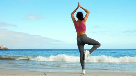 Fit-woman-doing-yoga-on-the-beach