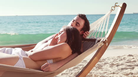 Couple-relaxing-in-hammock-at-the-beach-