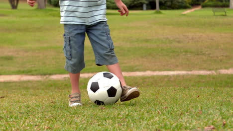Little-boy-playing-with-a-soccer-ball-in-the-park