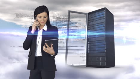 Businesswoman-having-phone-call-and-holding-tablet-computer-in-front-of-server-tower