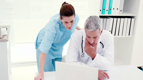 Concentrated-doctors-looking-at-laptop