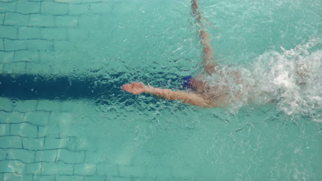 Above-view-of-swimmer-diving-into-pool