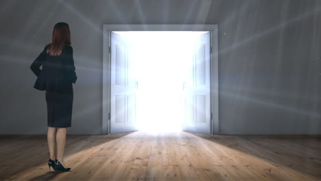 Door-opening-to-light-watched-by-businesswoman