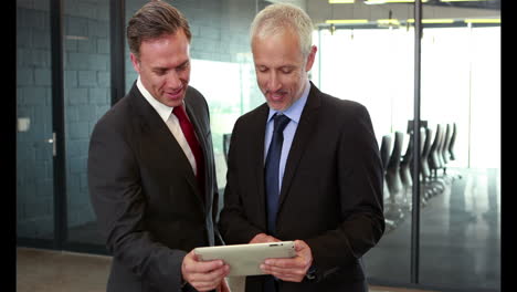 Businessmen-looking-at-tablet