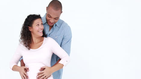 Pregnant-woman-and-husband-with-arms-around