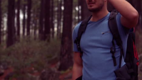 Man-hiking-through-a-forest
