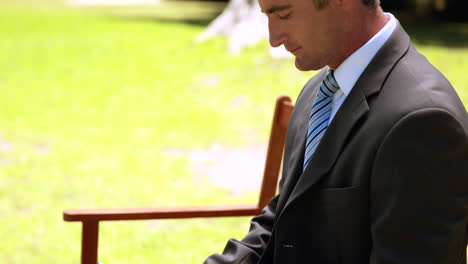 Businessman-using-tablet-in-the-park