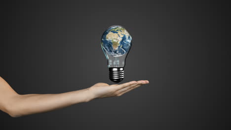 Hand-presenting-light-bulb-with-earth