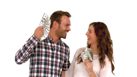 Happy-couple-waving-money