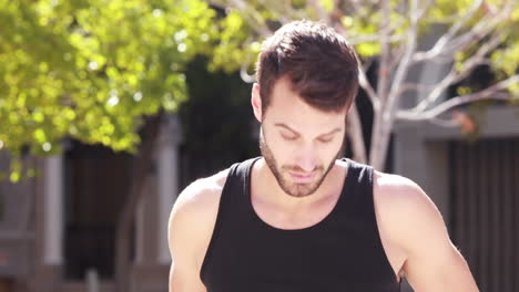 Handsome-jogger-stretching-before-running-