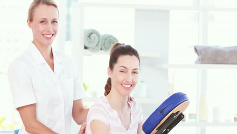 Physiotherapist-and-patient-smiling-at-camera-