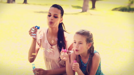 Mother-and-daughter-blowing-bubbles