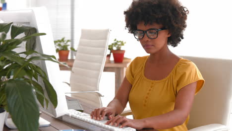Creative-businesswoman-typing-on-computer