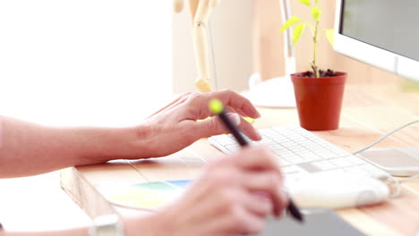 Casual-designer-working-at-her-desk