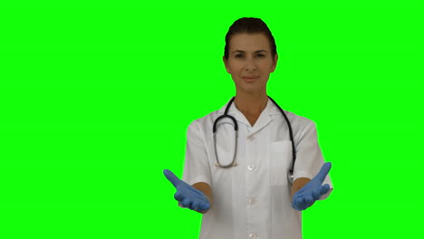 Smiling-female-doctor-presenting-with-hands