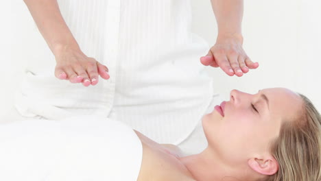 -Calm-woman-receiving-reiki-treatment