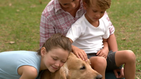 Happy-family-playing-with-their-dog-