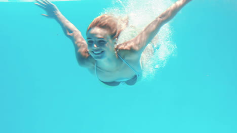Attractive-woman-diving-in-the-pool