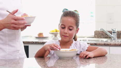 Mother-and-her-daughter-eating-cereals-together