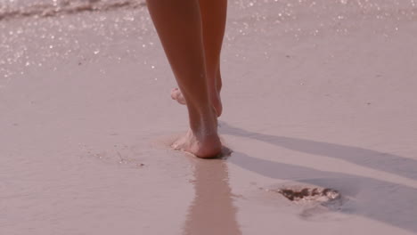 Woman-walking-on-the-beach-bare-footed