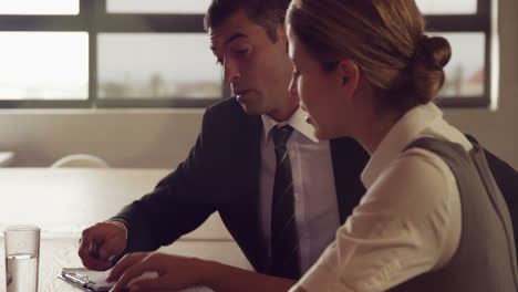 Serious-business-people-working-together-while-looking-tablet