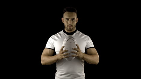 Serious-rugby-player-holds-rugby-ball