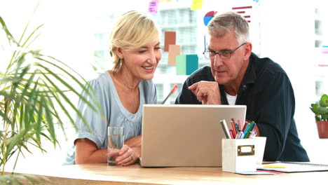 -Casual-business-partners-looking-at-tablet