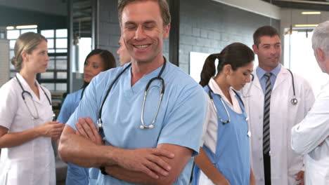 Smiling-doctor-posing-with-crossed-arms-