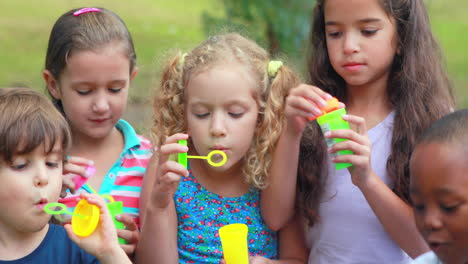 -Kinder-Spielen-Mit-Seifenblasenstäben-Im-Park