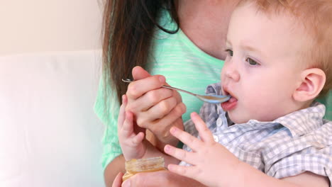 Happy-mother-feeding-her-baby-boy