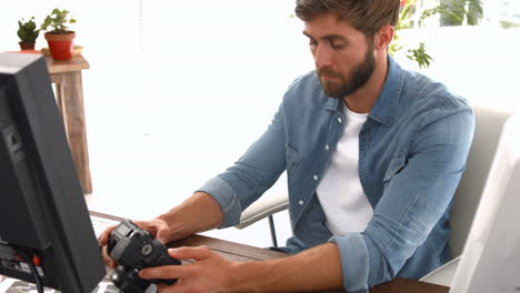 Casual-businessman-looking-at-picture-on-camera-