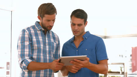 Casual-businessmen-using-tablet-computer-