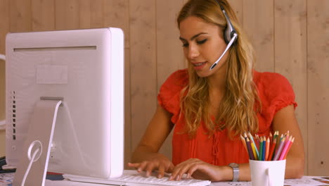 Pretty-worker-using-video-chat-at-desk