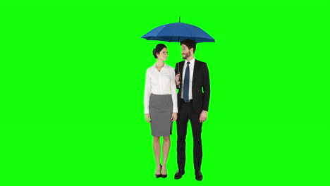 Business-people-standing-under-umbrella