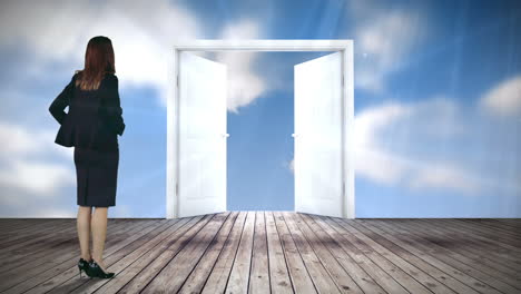 Door-opening-to-blue-sky-watched-by-businesswoman