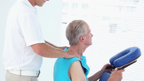 Doctor-massaging-his-patients-shoulders