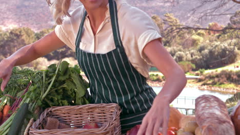 Smiling-blonde-farmer-with-her-products-in-slow-motion