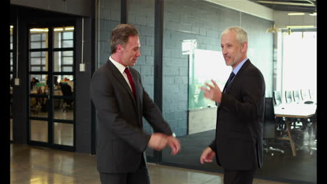 Businessmen-handshaking-and-talking