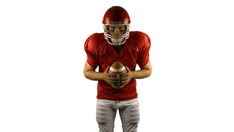 Red-american-football-player-holding-a-ball