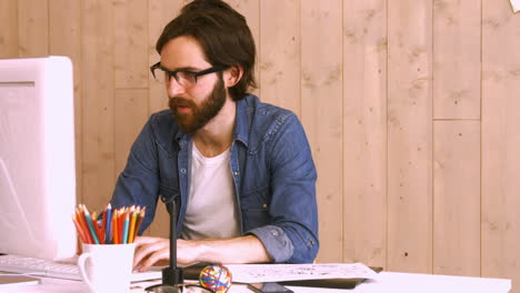 Casual-worker-using-computer-at-desk