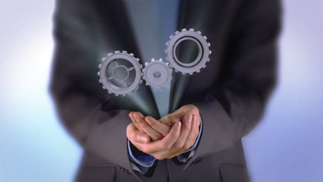 Businessman-presenting-cogs-and-wheels-graphic